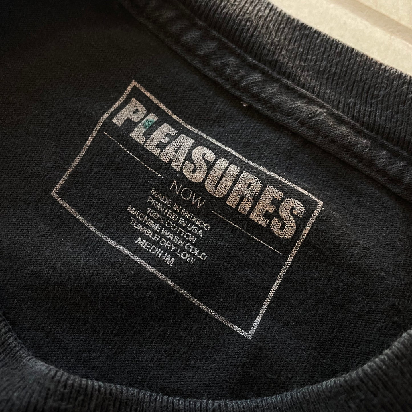 (M) PLEASURES Tee